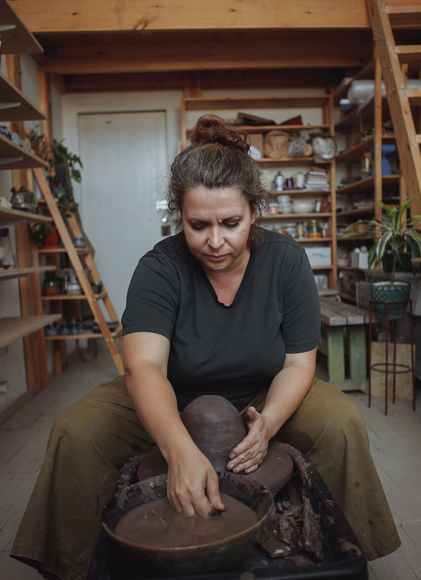 Woman molding clay.