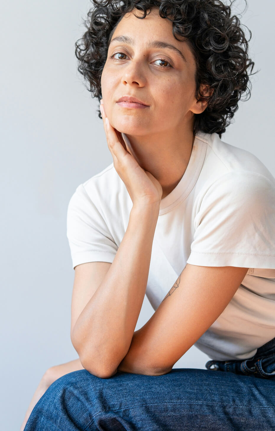 Woman sitting and leaning on hand