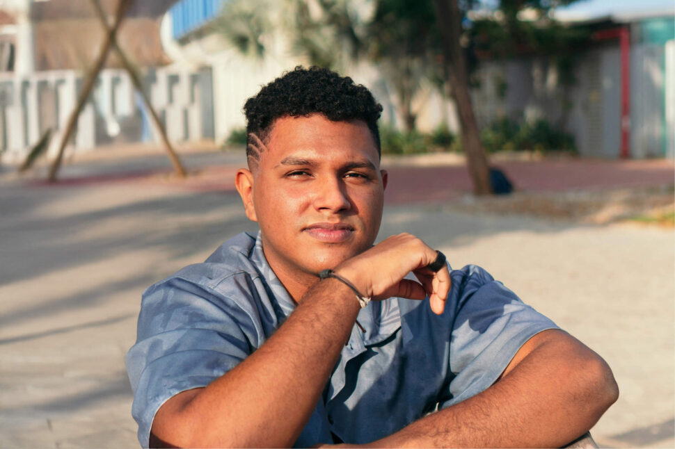 young man sitting outside in the sun