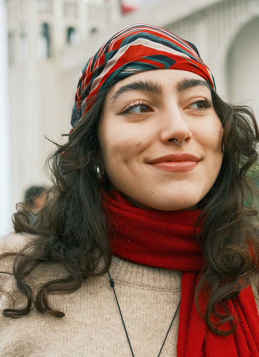 Girl smiling and wearing a red scarf