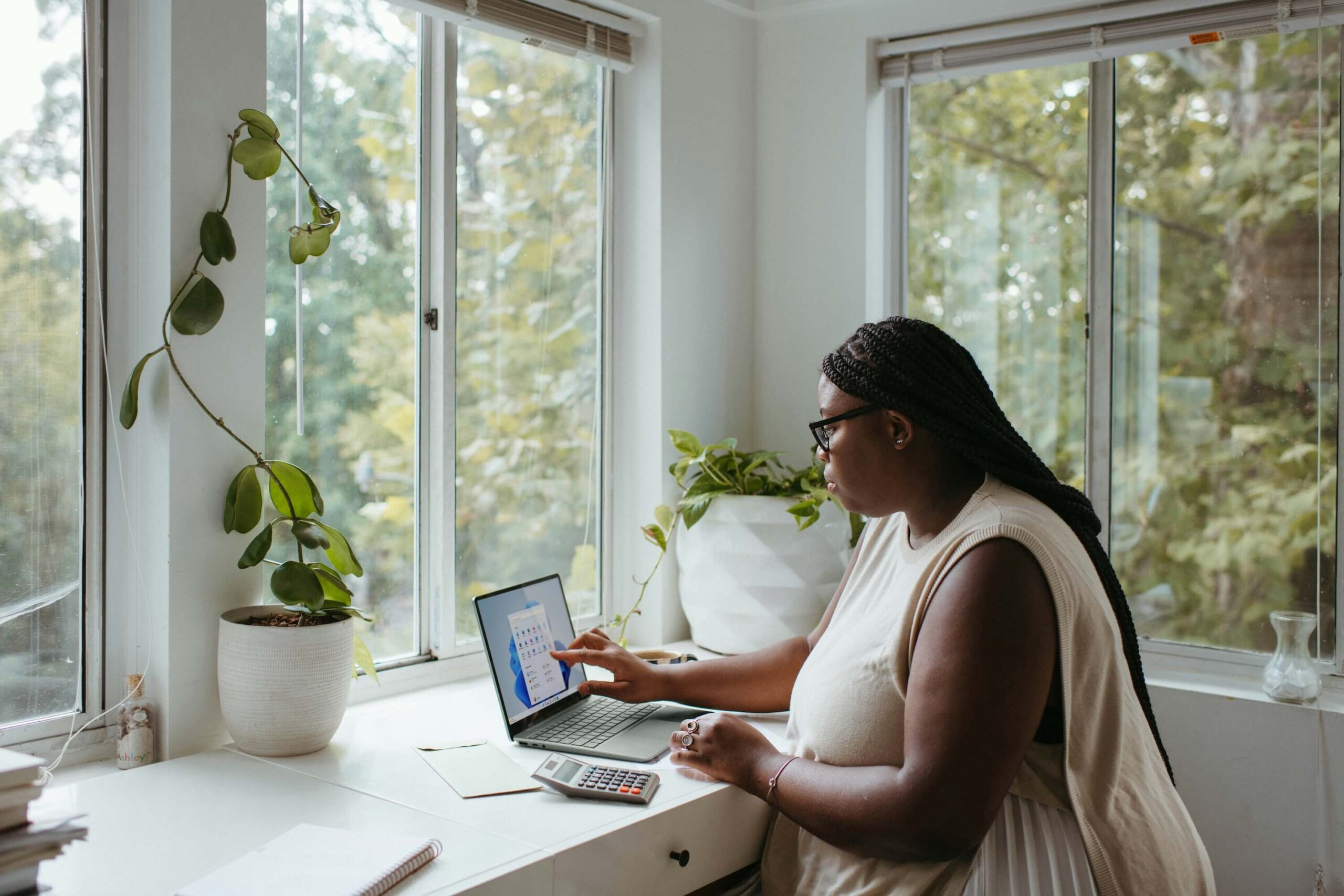 Woman sitting at desk working on laptop at home