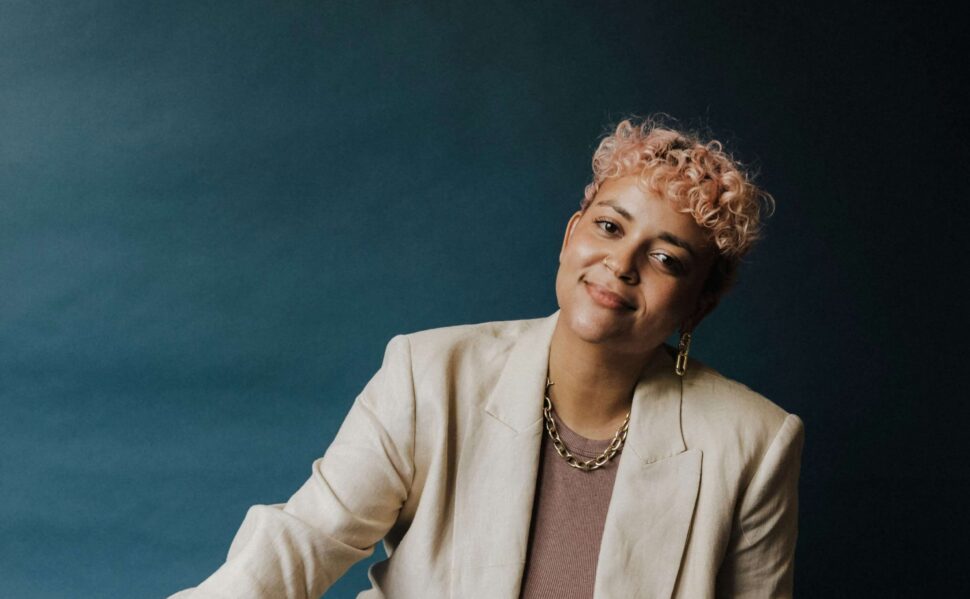 woman in a suit sitting on the ground