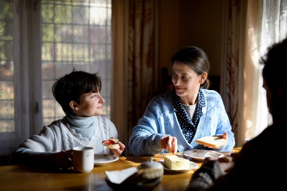 family sitting at dinning table eating